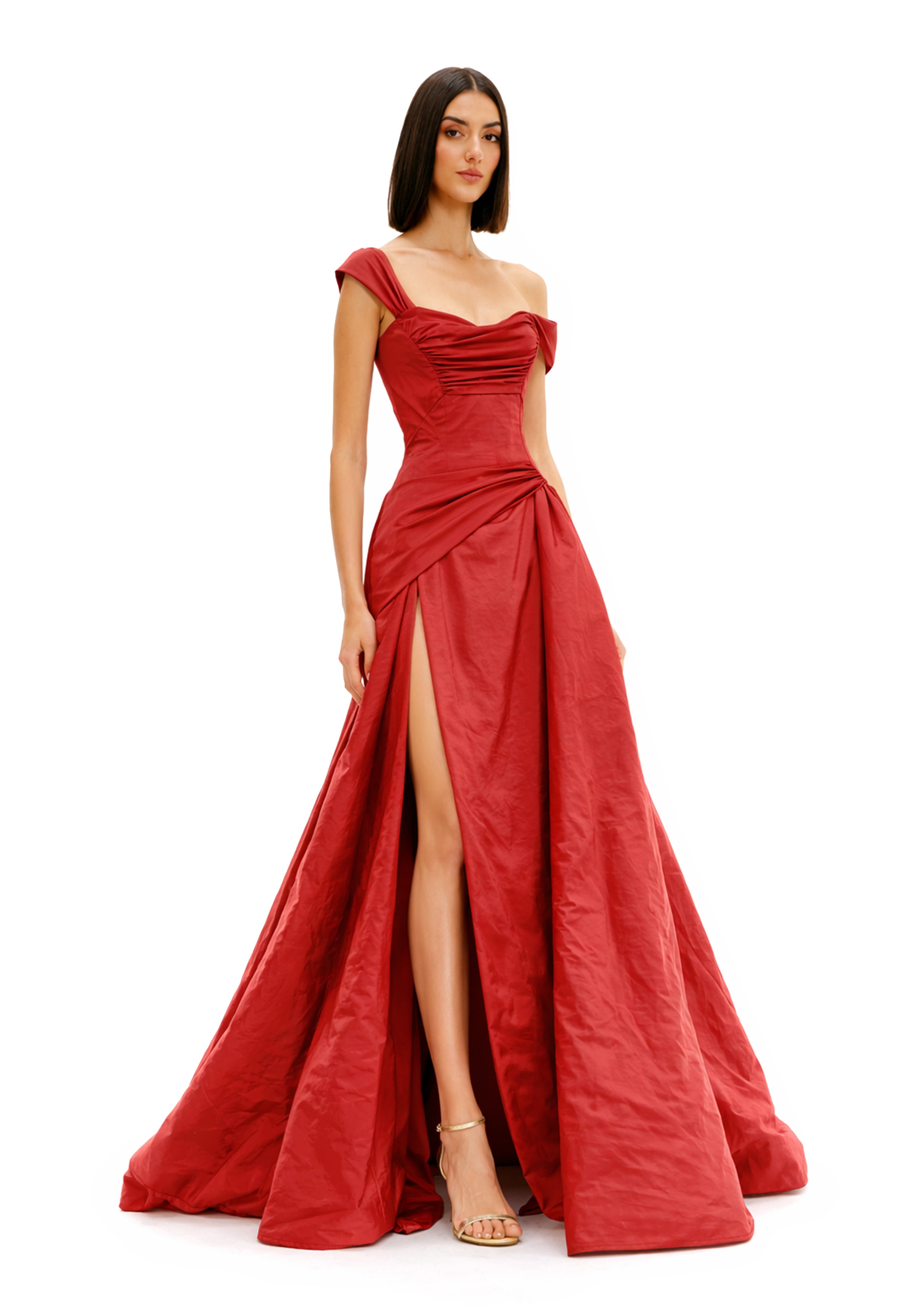 ONE-SHOULDER DRAPED BALL GOWN in red with a thigh-high slit, showcasing elegant draping and sophisticated design.