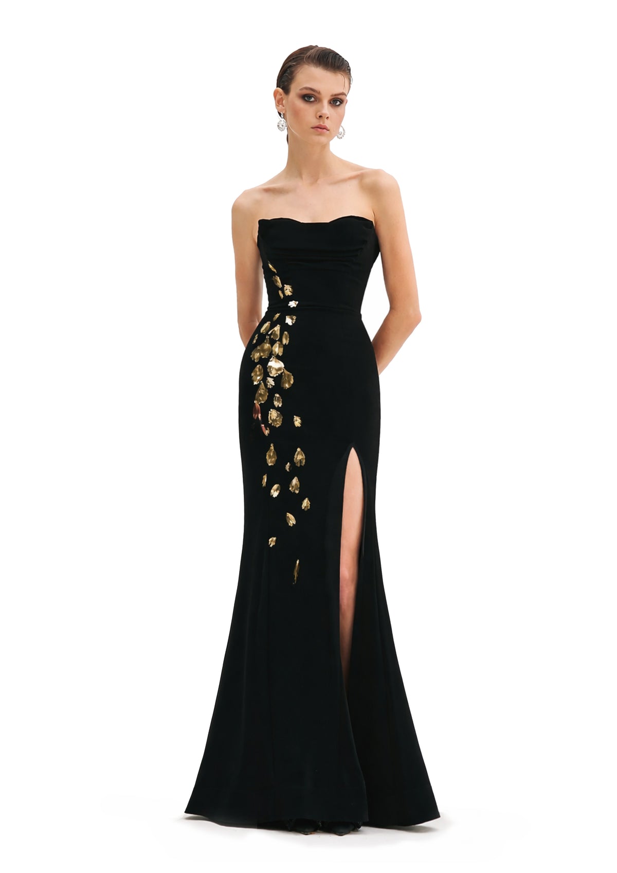 Model wearing Avaro Figlio black strapless evening gown with gold embroidery and a fitted silhouette.