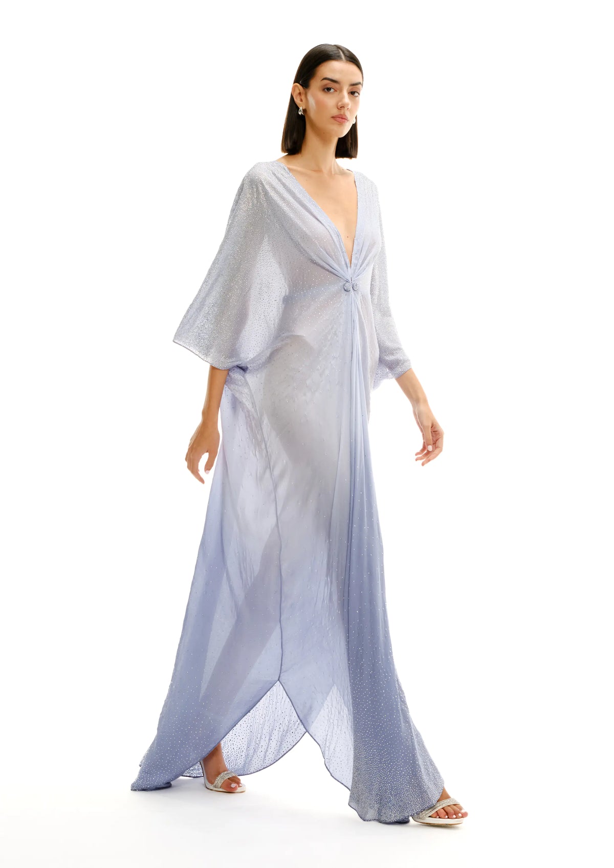 Model wearing Avaro Figlio light celestial blue maxi caftan dress with a V-neckline, draped tie detail at the bust, and flowing sheer fabric, shown on a plain white background.