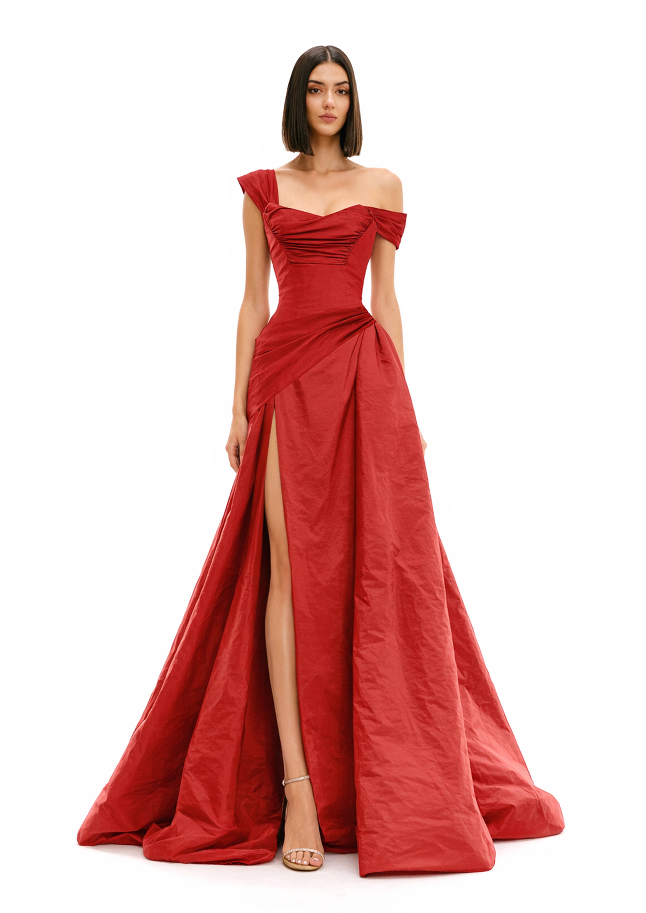 ONE-SHOULDER DRAPED BALL GOWN in luxurious red fabric with a thigh-high slit and elegant draping details.