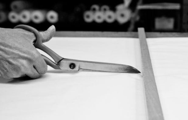 Couture craftsmanship at the Avaro Figlio atelier, hands at work on fabric