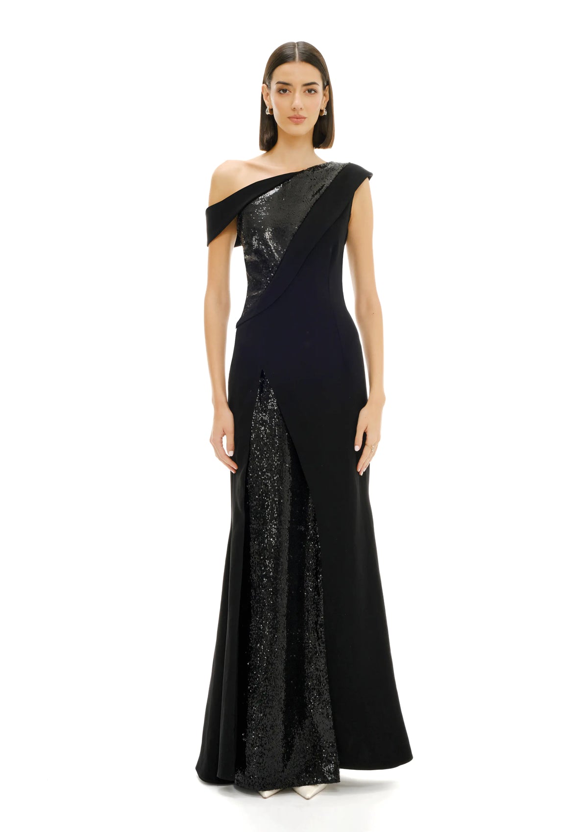 Model wearing a black one-shoulder evening Avaro Figlio gown with sequin detailing on a white background