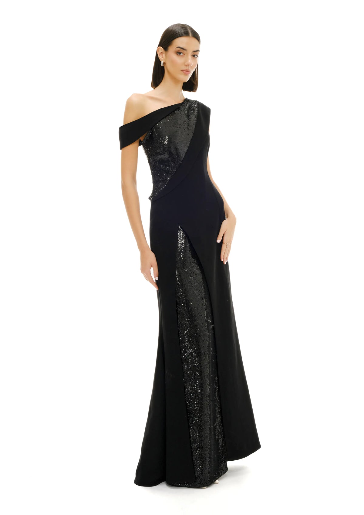 Model wearing Avaro Figlio black asymmetric sequin gown side view