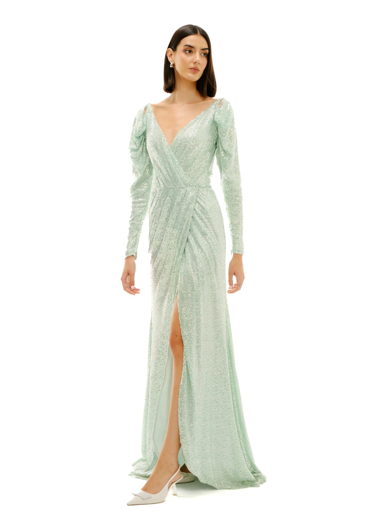Model wearing Avaro Figlio pastel green wrap around long sleeve sequin dress
