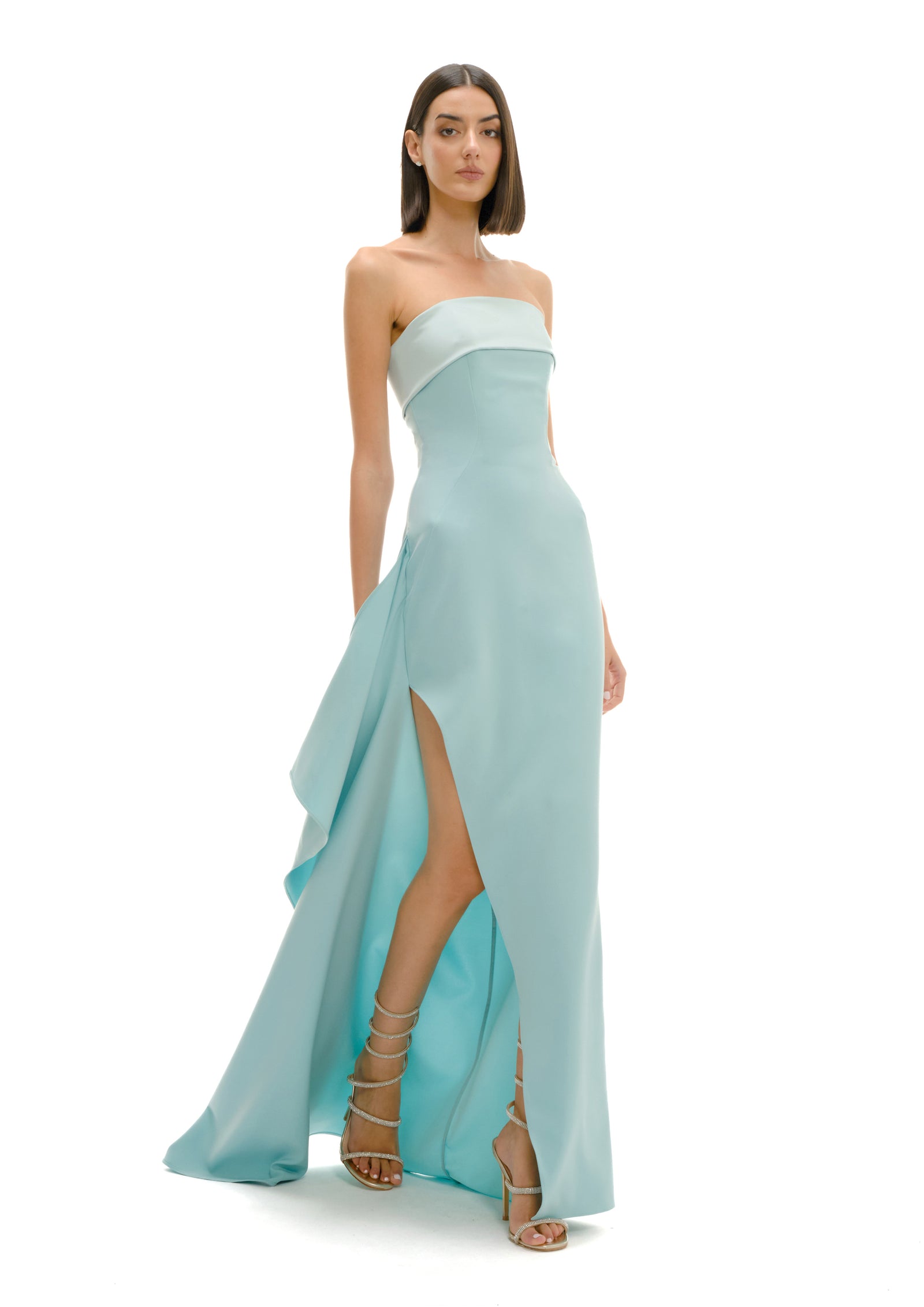 Model in pale green fluid draped gown, SS26 soft light study, Milan
