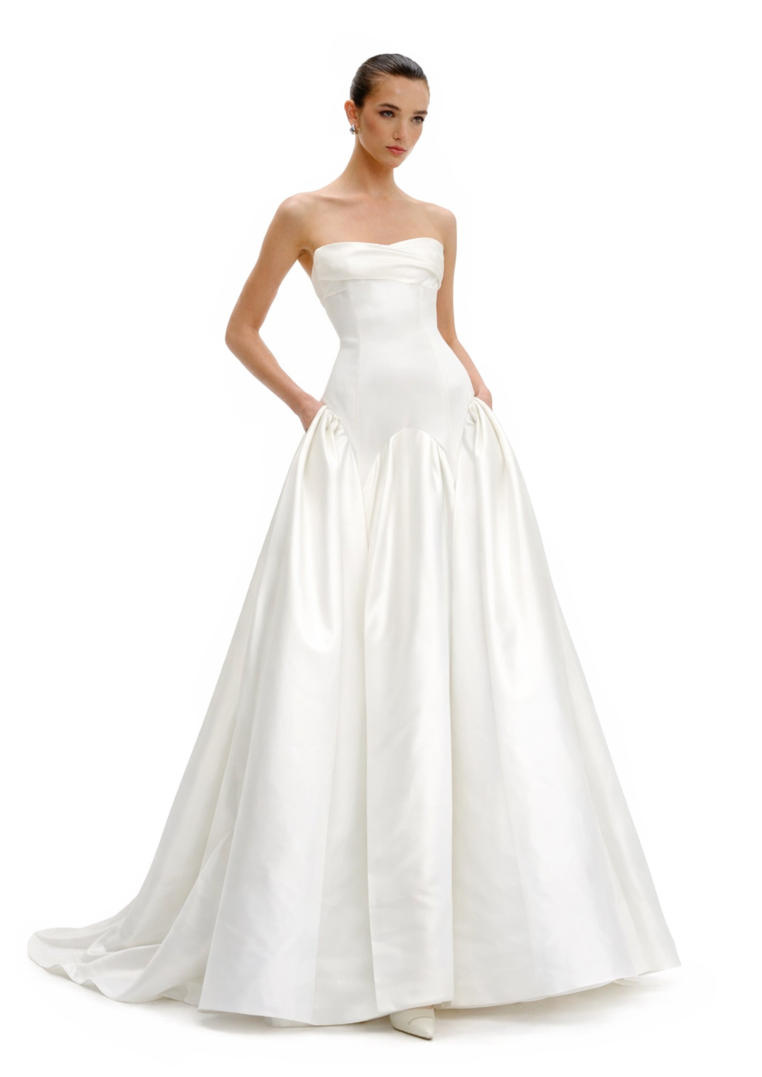 Model wearing strapless ball gown with voluminous skirt side view by Avaro Figlio